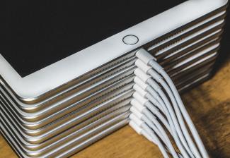 Stapel weißer iPads mit Kabel