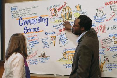 "Anu Frank-Lawale (right) and a VIMS student (left) discuss the graphic facilitation that Julie Stuart did during the communicating science panel. ©Will Sweatt/VASG" by Virginia Sea Grant is marked with CC BY-ND 2.0. To view the terms, visit https://creativecommons.org/licenses/by-nd/2.0/?ref=openverse 