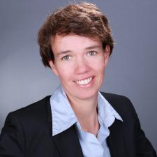 Porträt von Prof. Dr. Claudia Hildebrandt vor grauem Hintergrund. Bild: privat