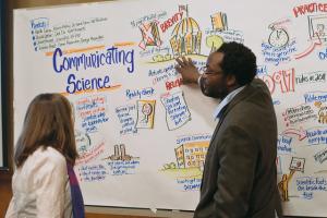 "Anu Frank-Lawale (right) and a VIMS student (left) discuss the graphic facilitation that Julie Stuart did during the communicating science panel. ©Will Sweatt/VASG" by Virginia Sea Grant is marked with CC BY-ND 2.0. To view the terms, visit https://creativecommons.org/licenses/by-nd/2.0/?ref=openverse 
